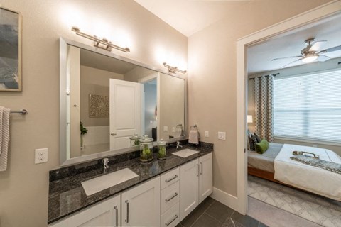 a bathroom with two sinks and a large mirror