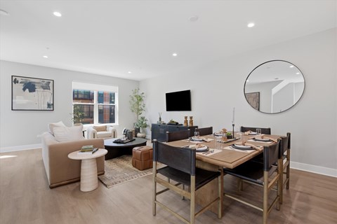 A modern dining room with a wooden table and chairs.