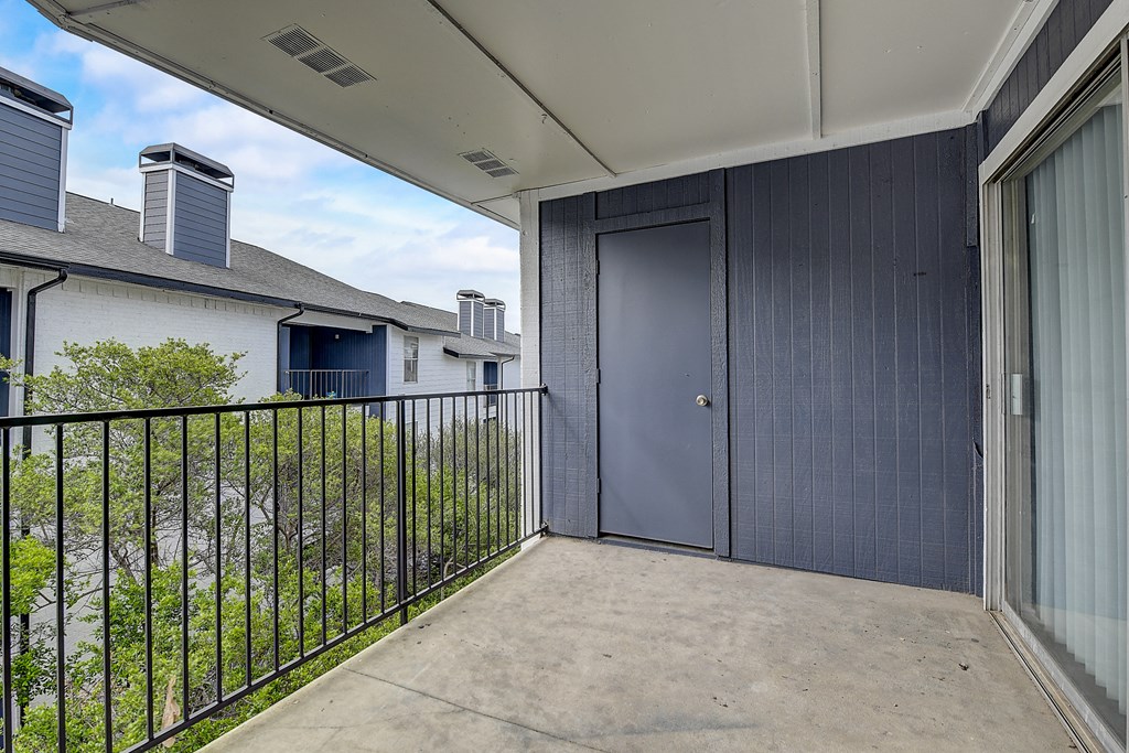 a large patio with a door that leads to the backyard