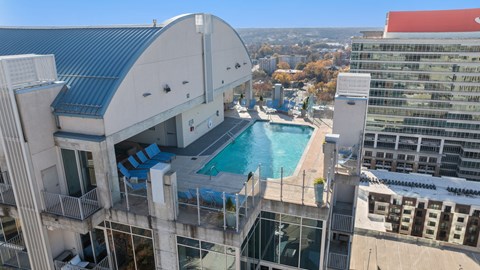 A large building with a pool on the roof.