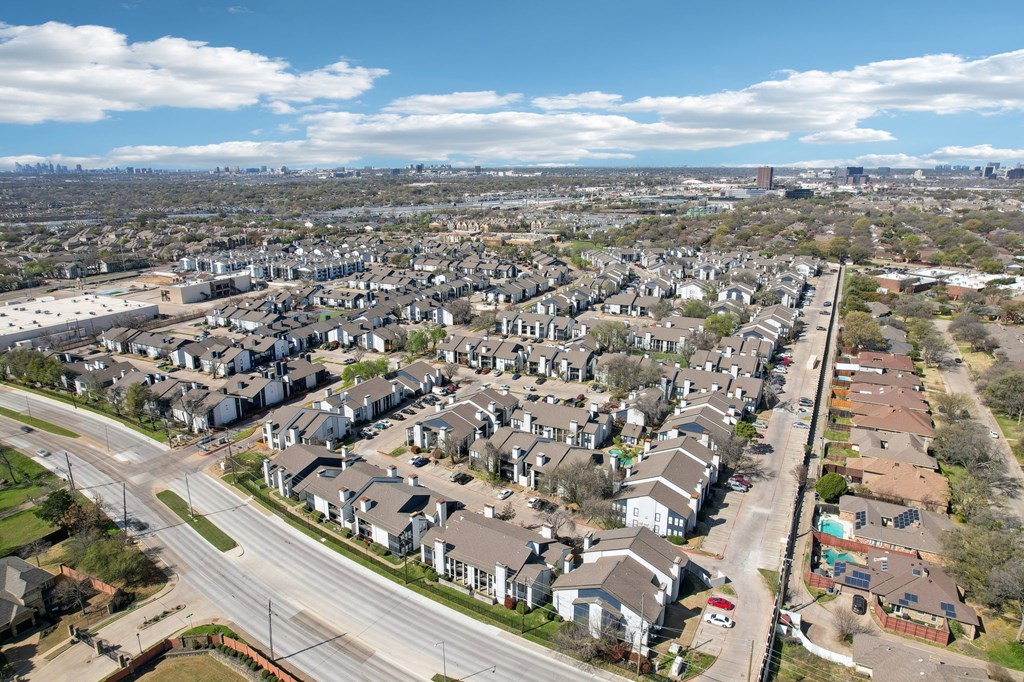 A suburban neighborhood with houses and a road.