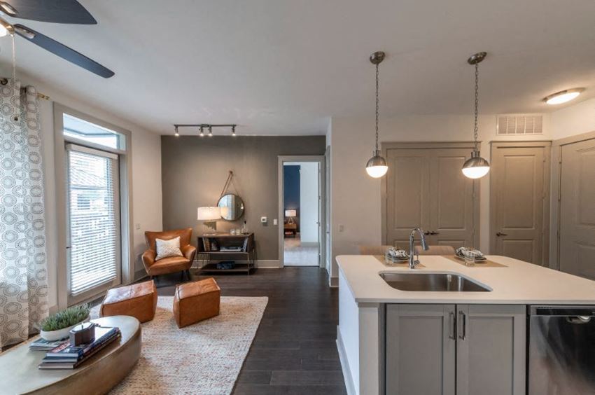 a kitchen and living room with a sink and a counter