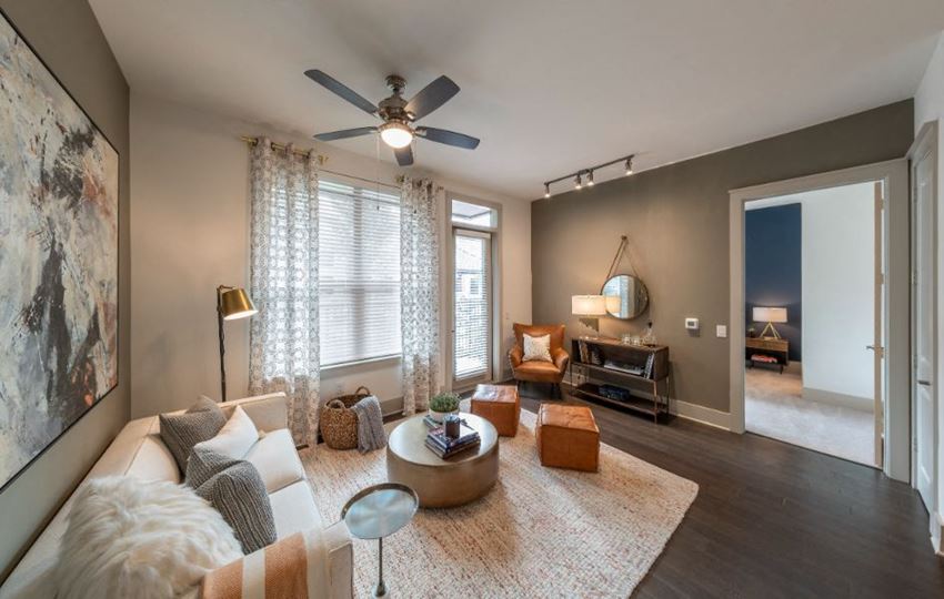 a living room with a couch and a ceiling fan
