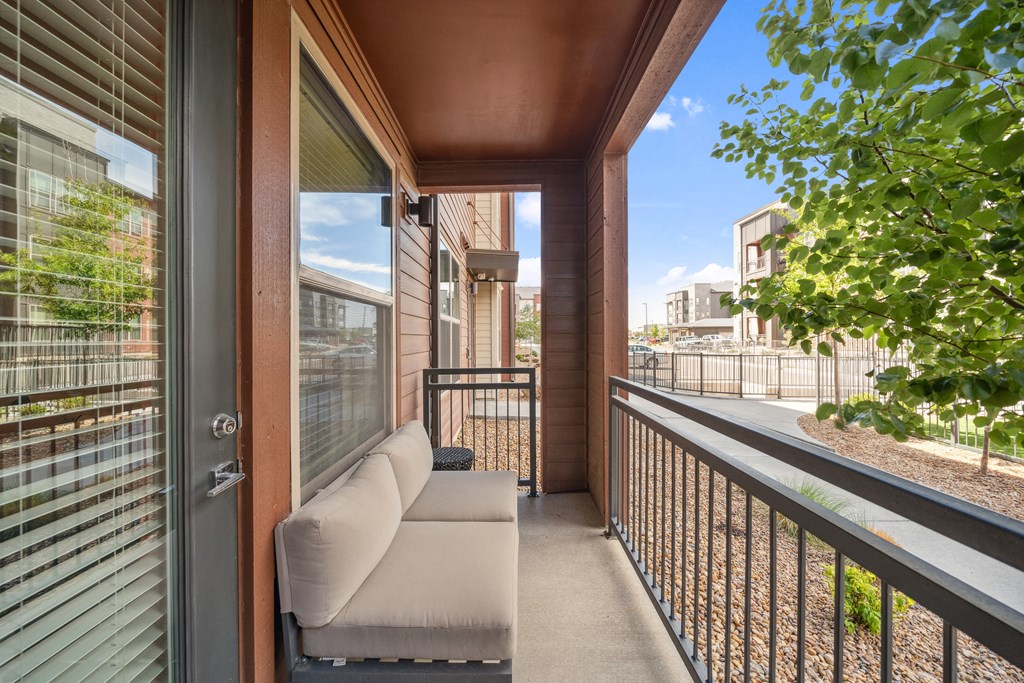 a balcony with a couch and a view of the city
