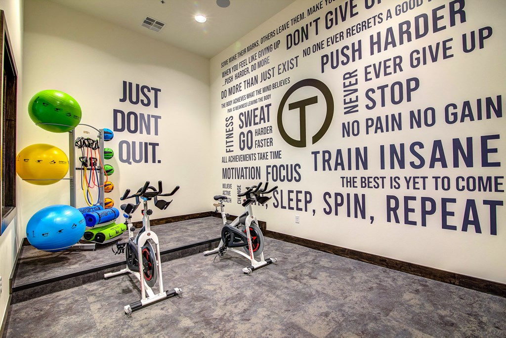 a wall in the gym with motivational quotes