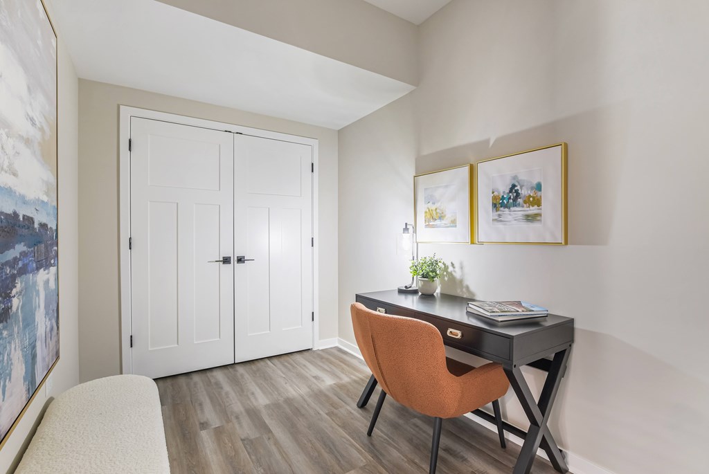 A room with a desk and a chair.