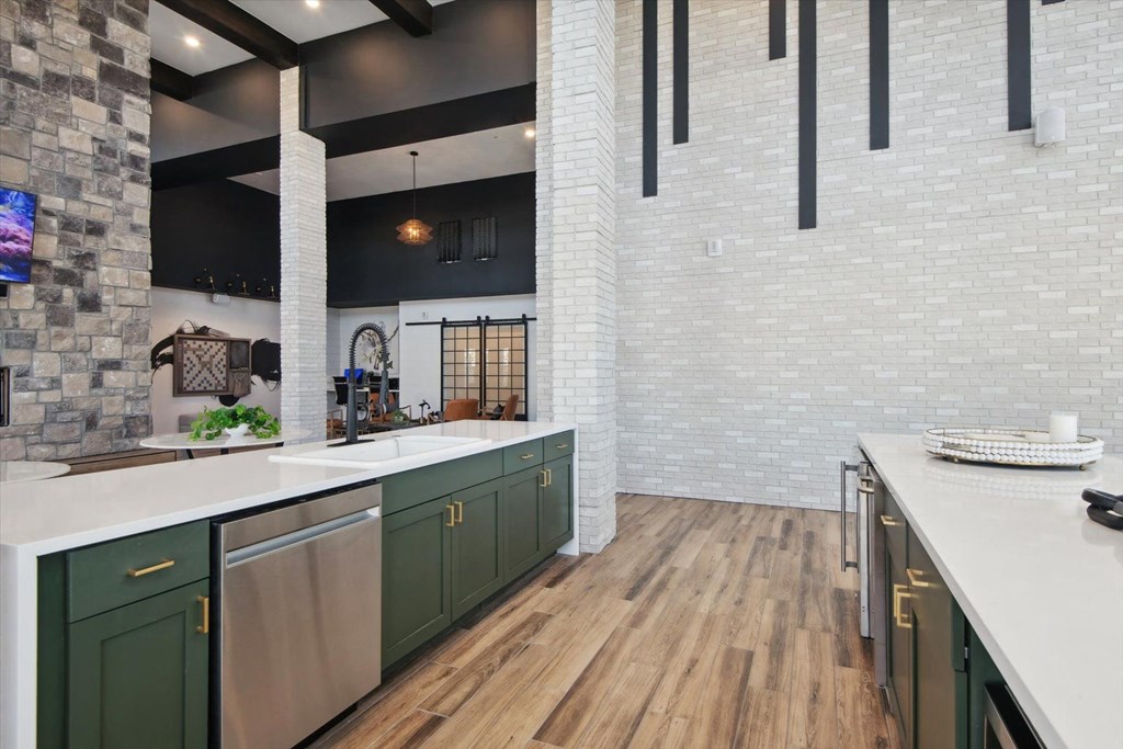 a large kitchen with white counter tops and green cabinets