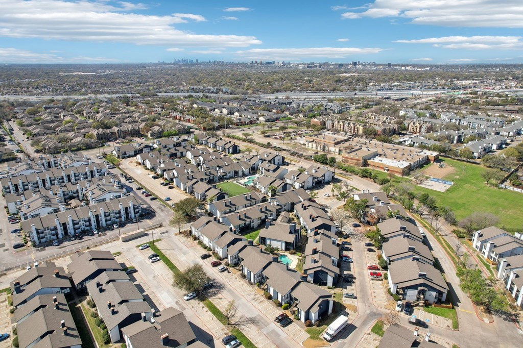 A bird's eye view of a residential area with houses and roads.