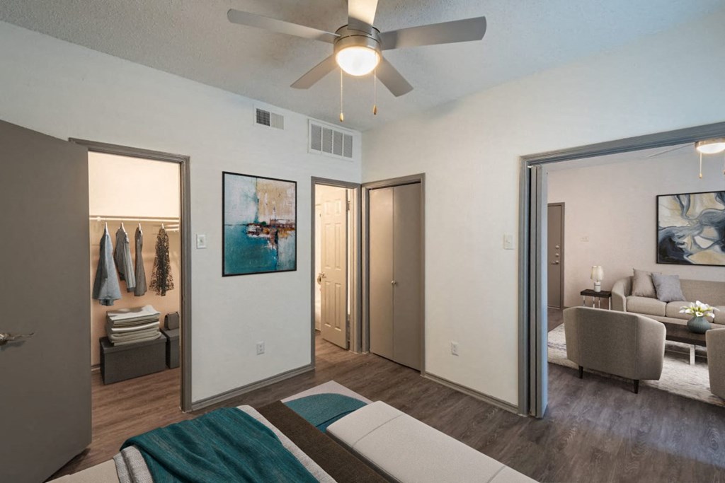 a living room with a ceiling fan and mirrors