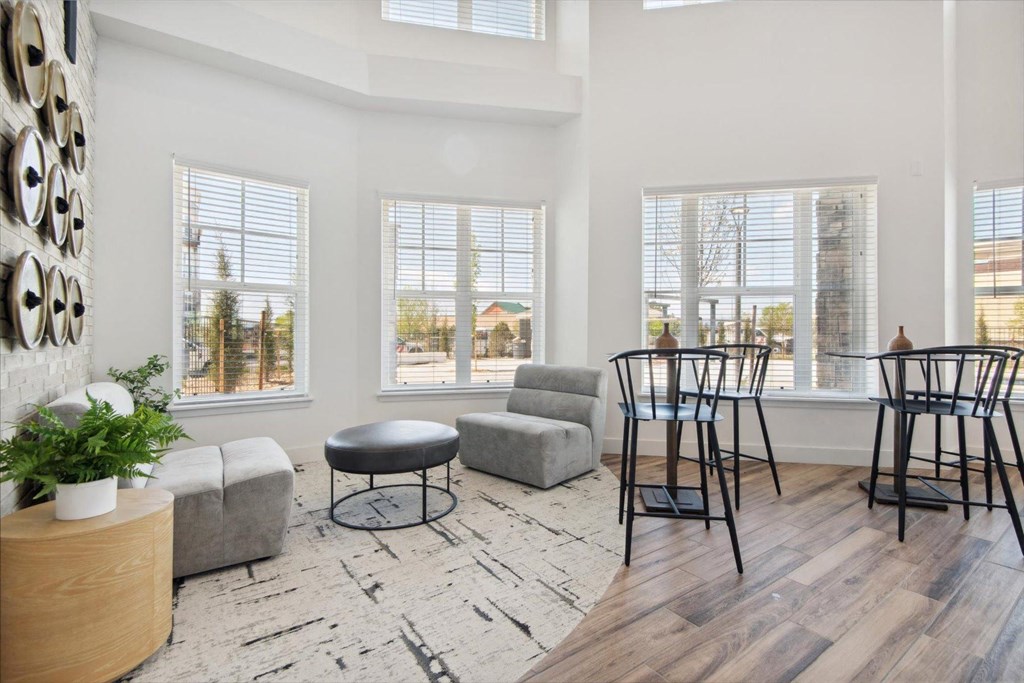 a living room with a dining room table and chairs