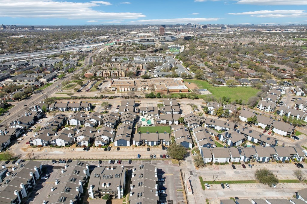 A suburban neighborhood with houses and apartment buildings.