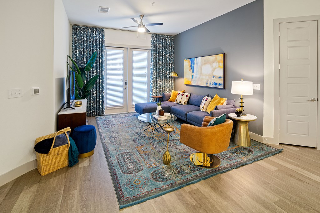 an open living room with blue walls and a ceiling fan