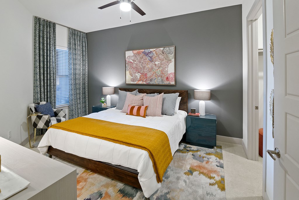 a bedroom with a bed and a ceiling fan