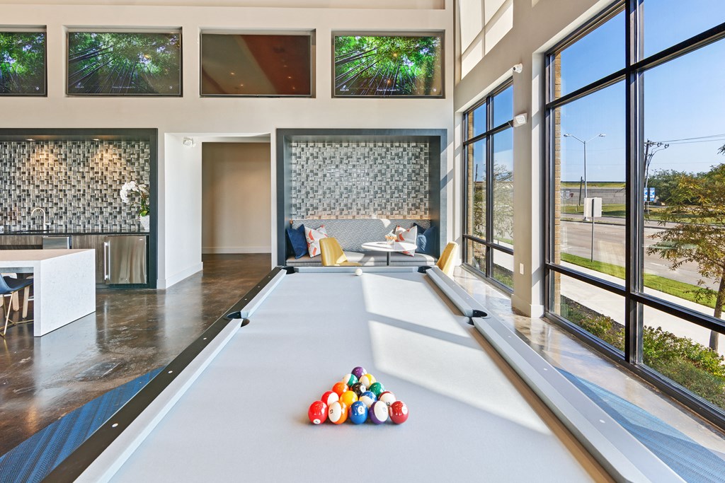 a billiards room with a pool table and a lot of colorful balls