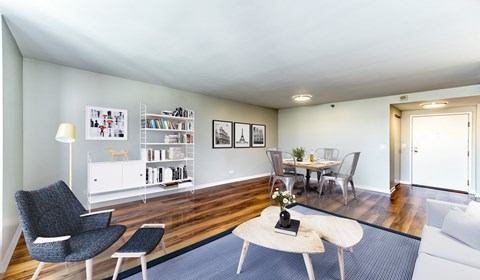 A living room with a grey chair and a white sofa.
