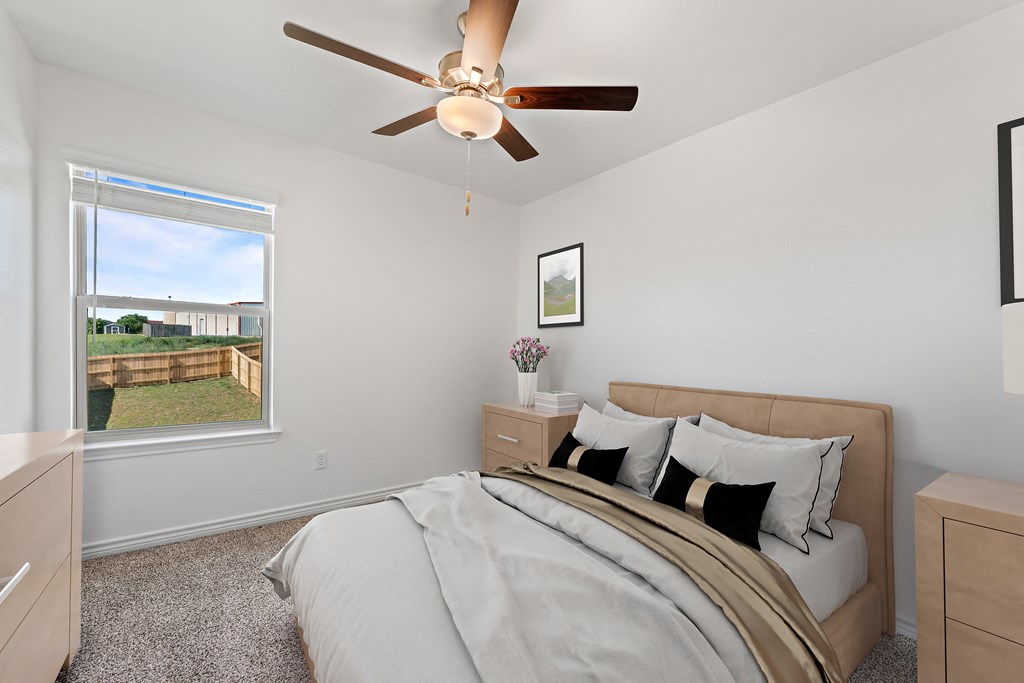 a bedroom with a large bed and a ceiling fan