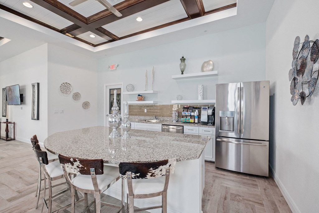 a kitchen with a marble counter top and stainless steel appliances