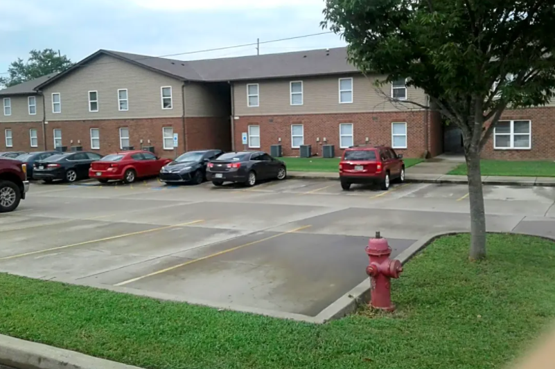 a fire hydrant in a parking lot in front of a building