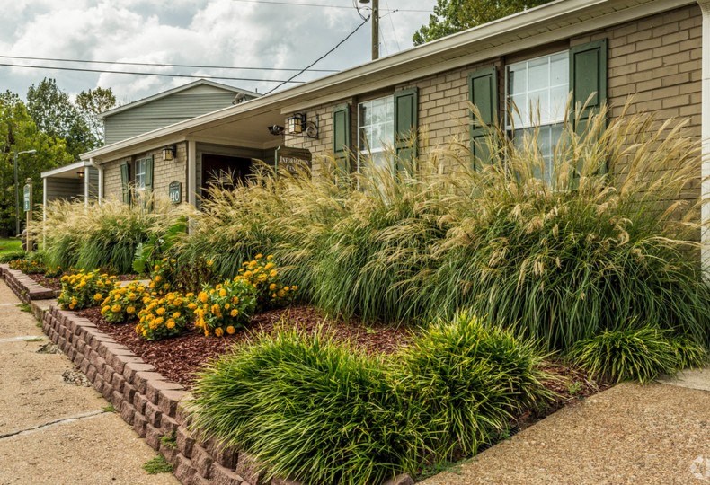 a house with a flower garden in front of it