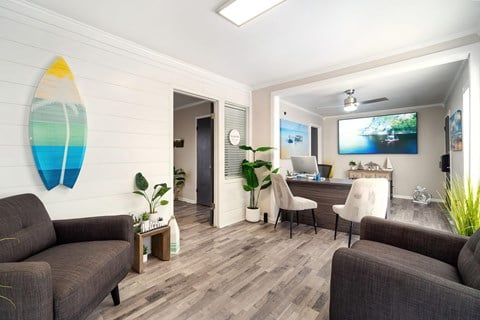a living room with furniture and a surfboard on the wall