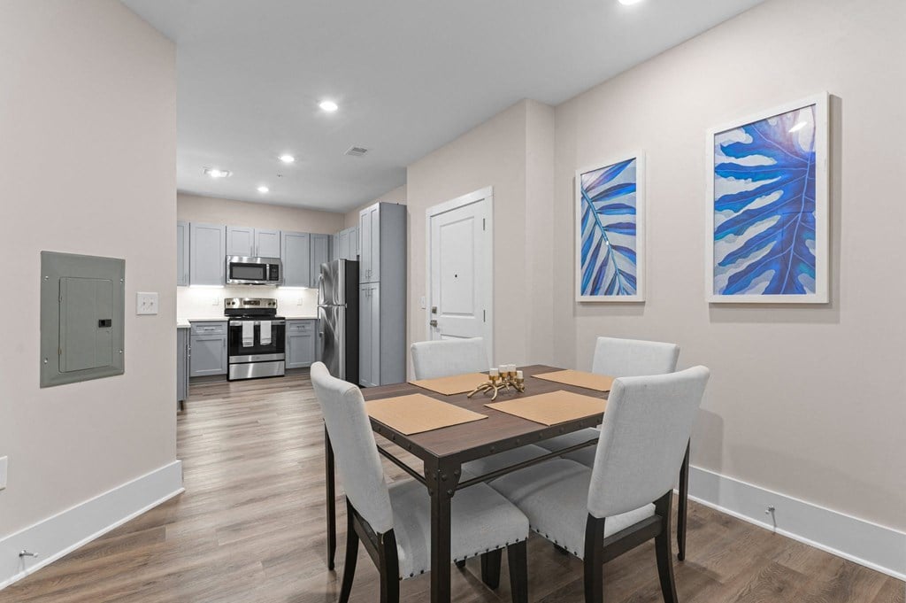 a dining room with a table and chairs and a kitchen