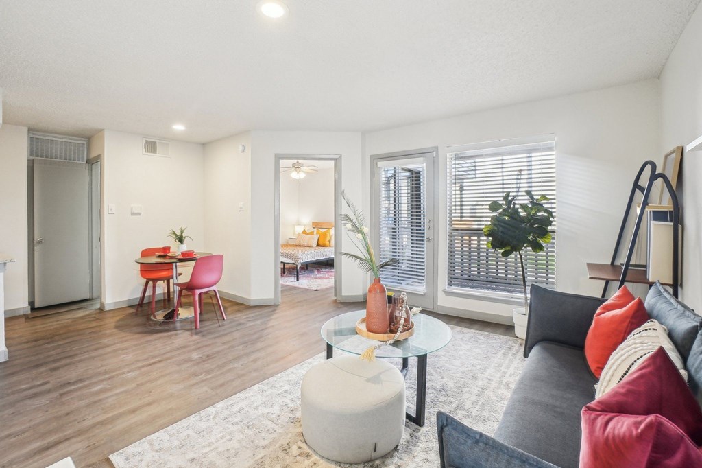 A living room with a grey couch and a white coffee table.