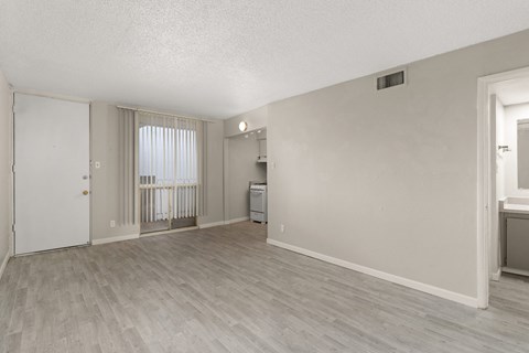 the living room and dining room of an apartment