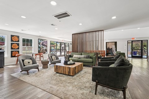 A living room with a green couch and a wooden coffee table.