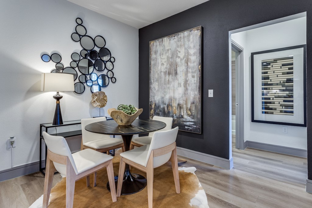 a dining room with a table and chairs