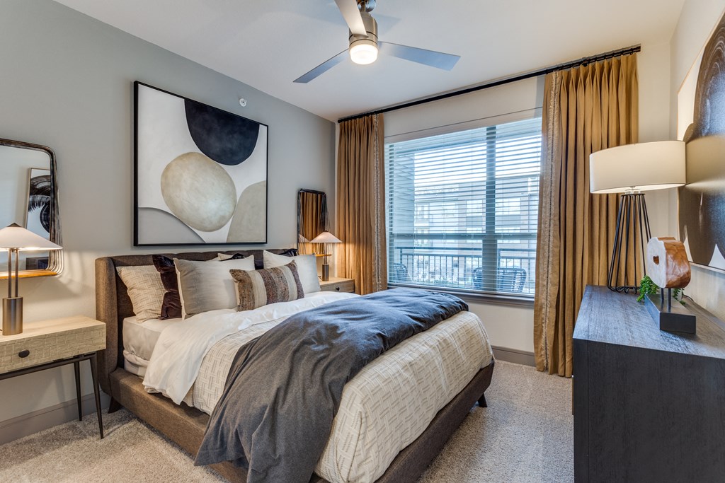 a bedroom with a large bed and a ceiling fan