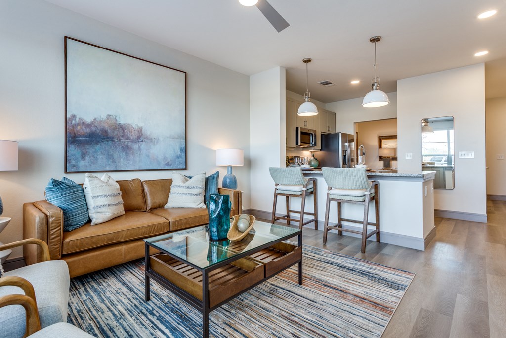 a living room with a couch and a glass coffee table