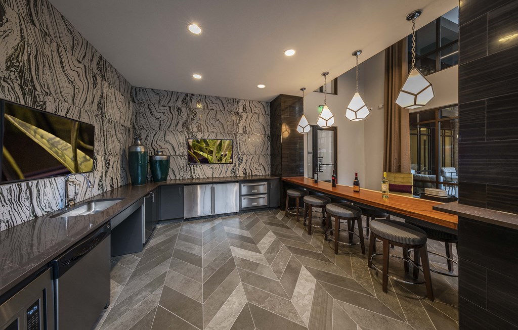a bar with stools and a counter with a wood countertop