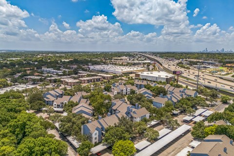 A bird's eye view of a residential area with houses and trees.