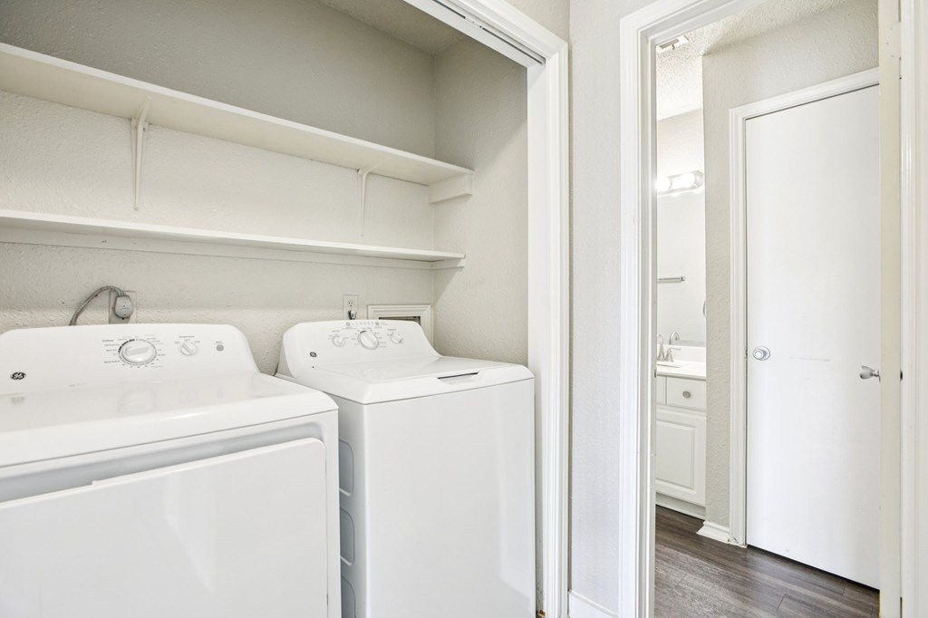 A white laundry room with a washer and dryer.