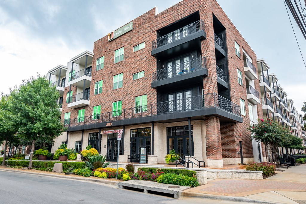 a red brick apartment building on a city street