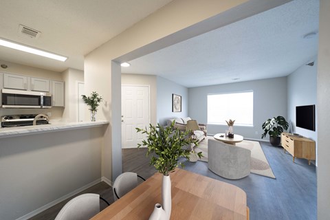 A modern kitchen with a dining table and chairs.