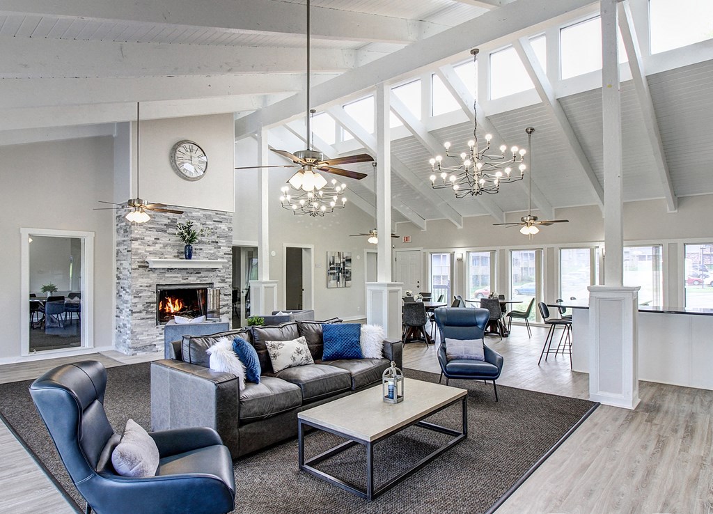 a living room with couches and chairs and a fireplace