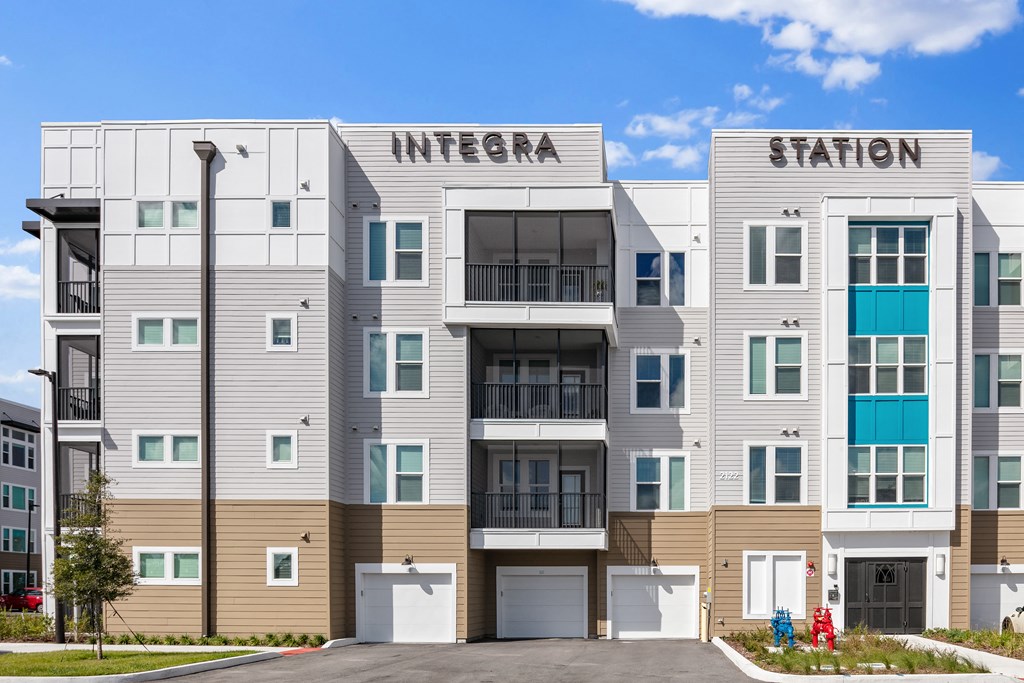 A modern apartment building named Integra Station is shown.