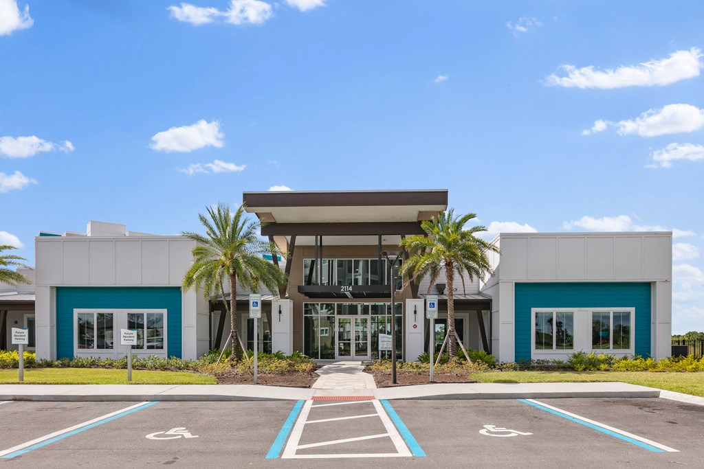 A modern building with a parking lot in front.