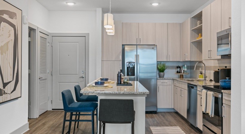 A kitchen with a table and chairs in the middle of the room.