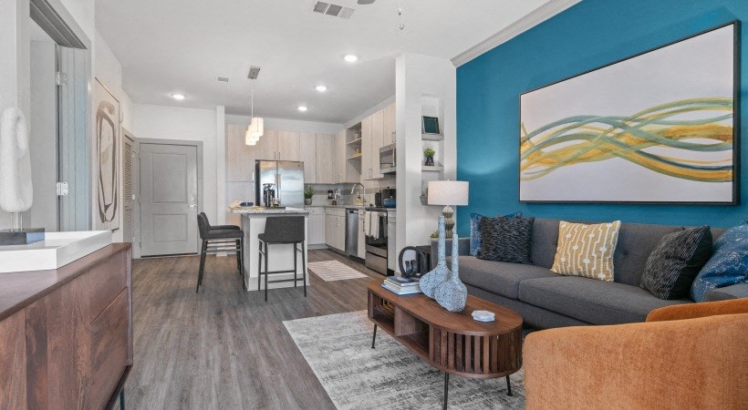 A modern kitchen with a dining area and a living room.