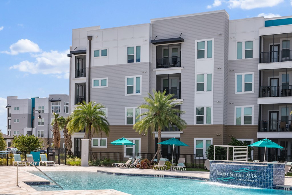 A pool in front of a building with a sign that reads "Incard Station 2114".