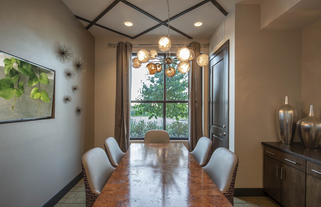 a dining room with a long table and chairs and a chandelier