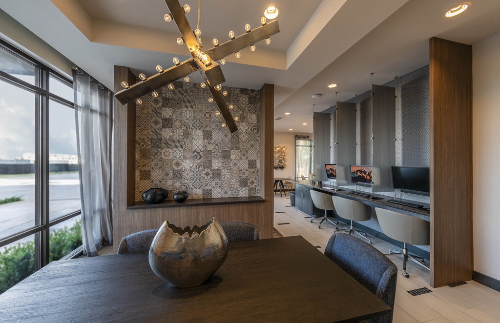 a dining room with a table and chairs and a chandelier