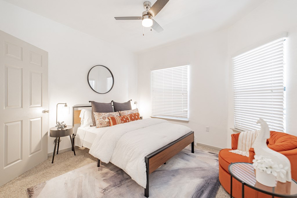 a bedroom with a large bed and a ceiling fan