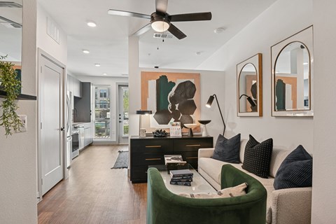 A modern living room with a green sofa and a black coffee table.