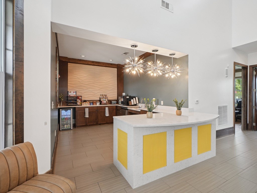 A reception area with a white and yellow reception desk.