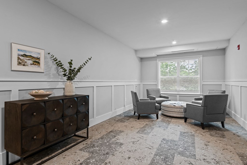 the living room of a home with two chairs and a couch