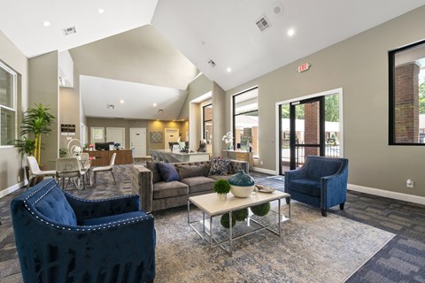 A living room with a blue chair and a white coffee table.