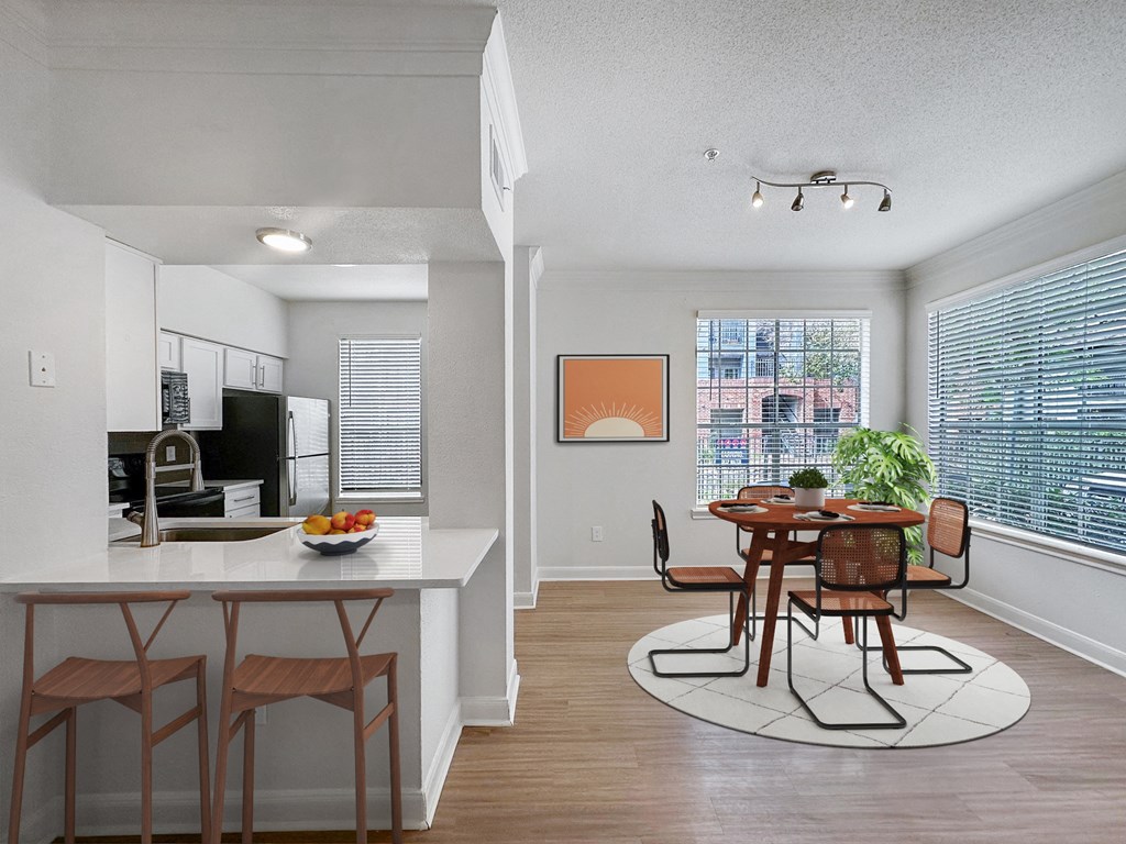 an open kitchen and dining room with a table and chairs